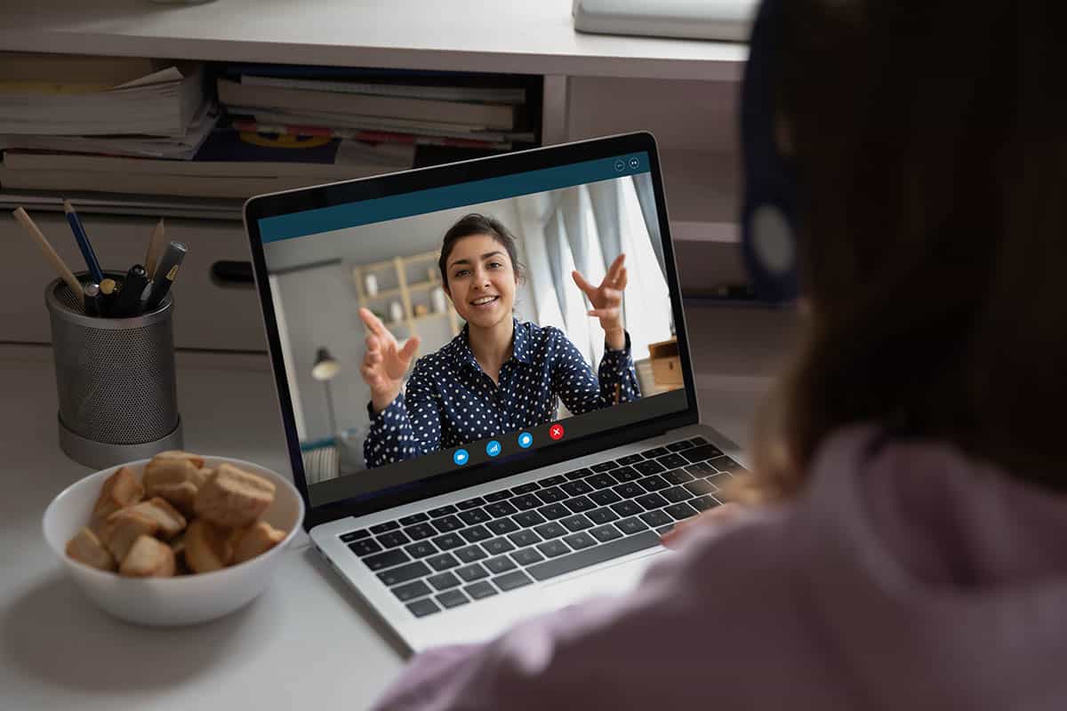 a therapist talks to a teen on a video call during Telehealth Services