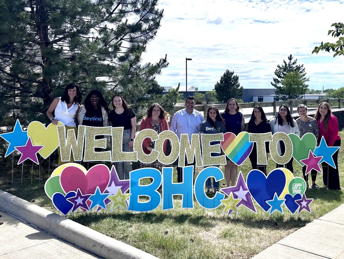 Beyond HC staff behind welcome sign