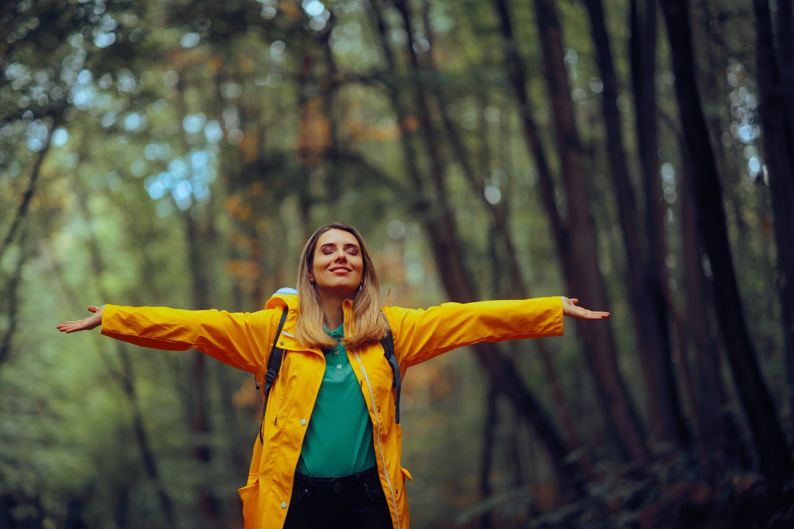 Happy woman enjoying the forest.